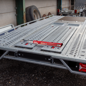Image of red SAS 5710781 Ramp Lock secuing ramps on Brian James T Transporter Car Trailer