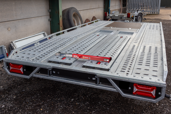 Image of red SAS 5710781 Ramp Lock secuing ramps on Brian James T Transporter Car Trailer