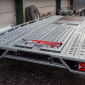 Image of red SAS 5710781 Ramp Lock secuing ramps on Brian James T Transporter Car Trailer